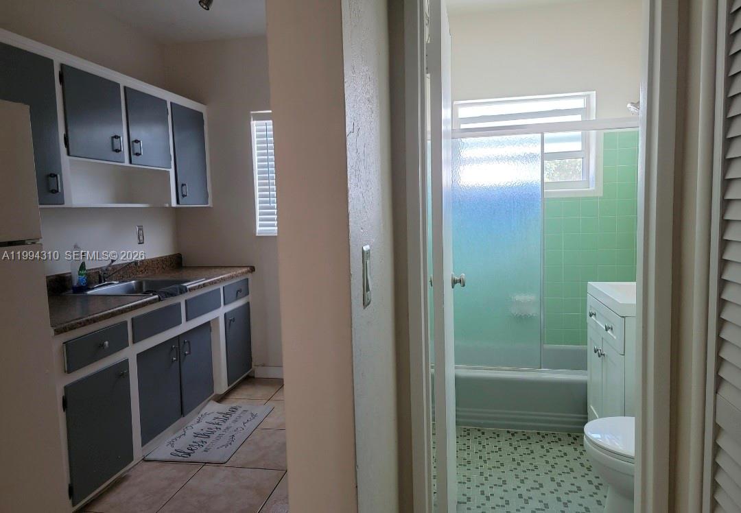 620 76th Street, Unit 11 Miami Beach, FL 33141 - Photo 6 of 14 a kitchen with a sink stove and refrigerator