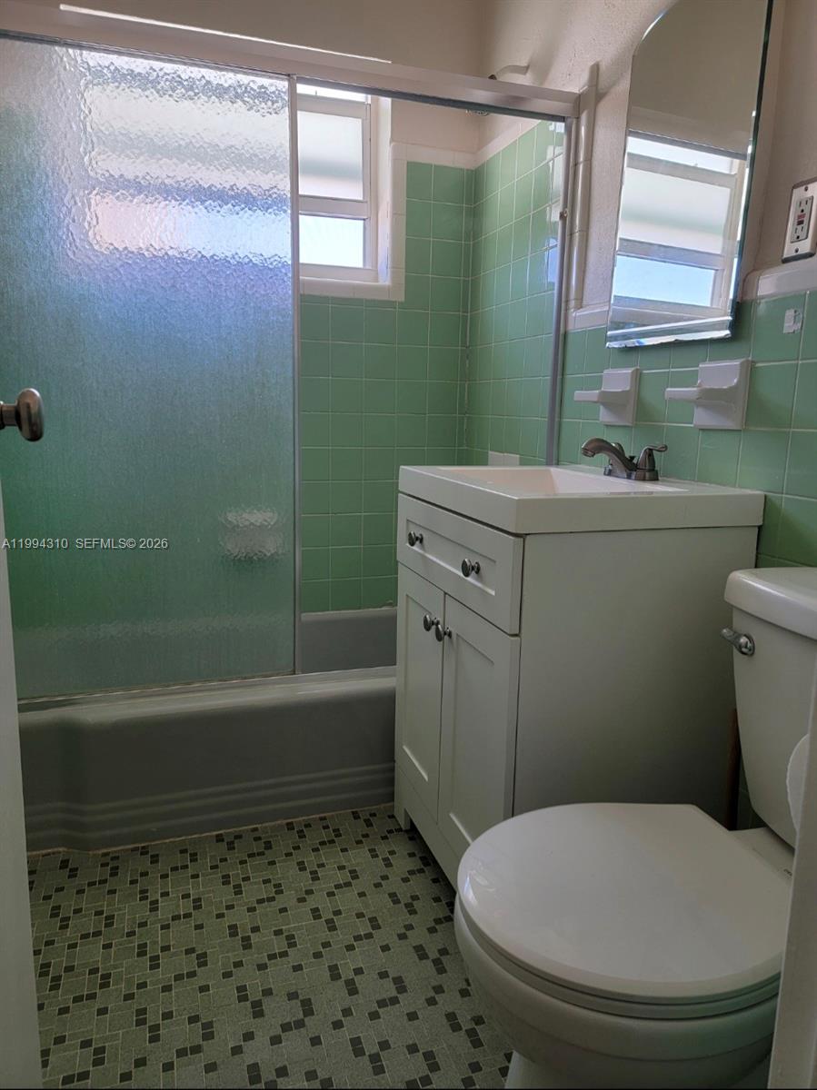 620 76th Street, Unit 11 Miami Beach, FL 33141 - Photo 9 of 14 a bathroom with a toilet a sink and bathtub