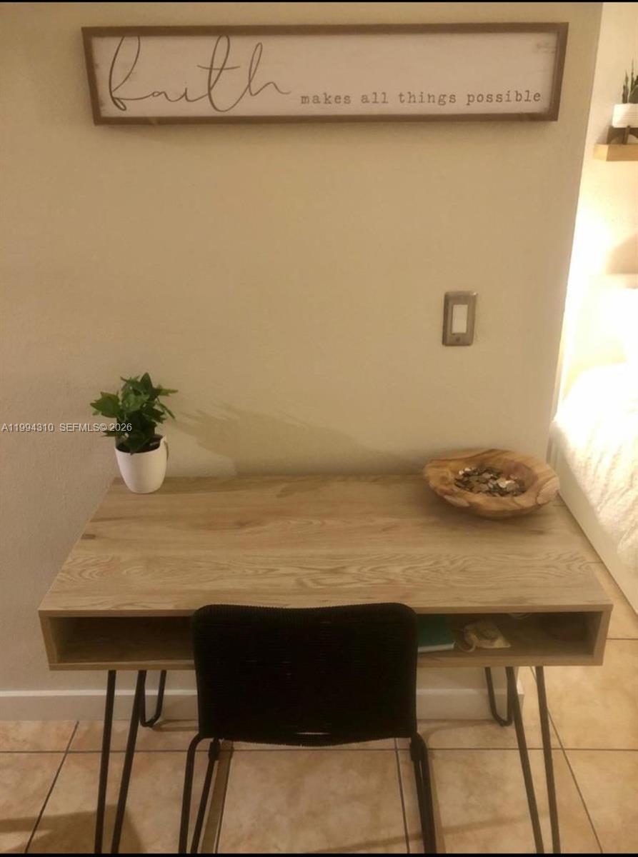 620 76th Street, Unit 11 Miami Beach, FL 33141 - Photo 10 of 14 a room with a table and a chair