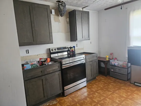 a kitchen with stainless steel appliances a refrigerator and a stove