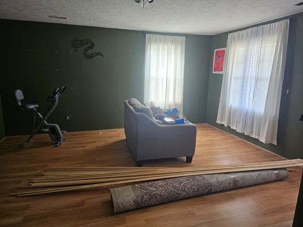 a view of a hardwood floor and staircase