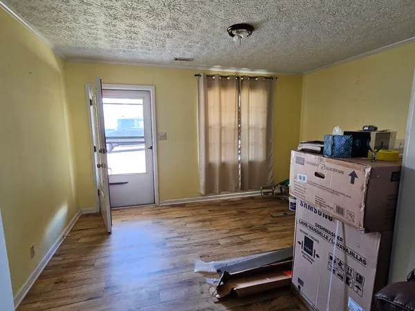 a living room with furniture gaming equipment and a fireplace