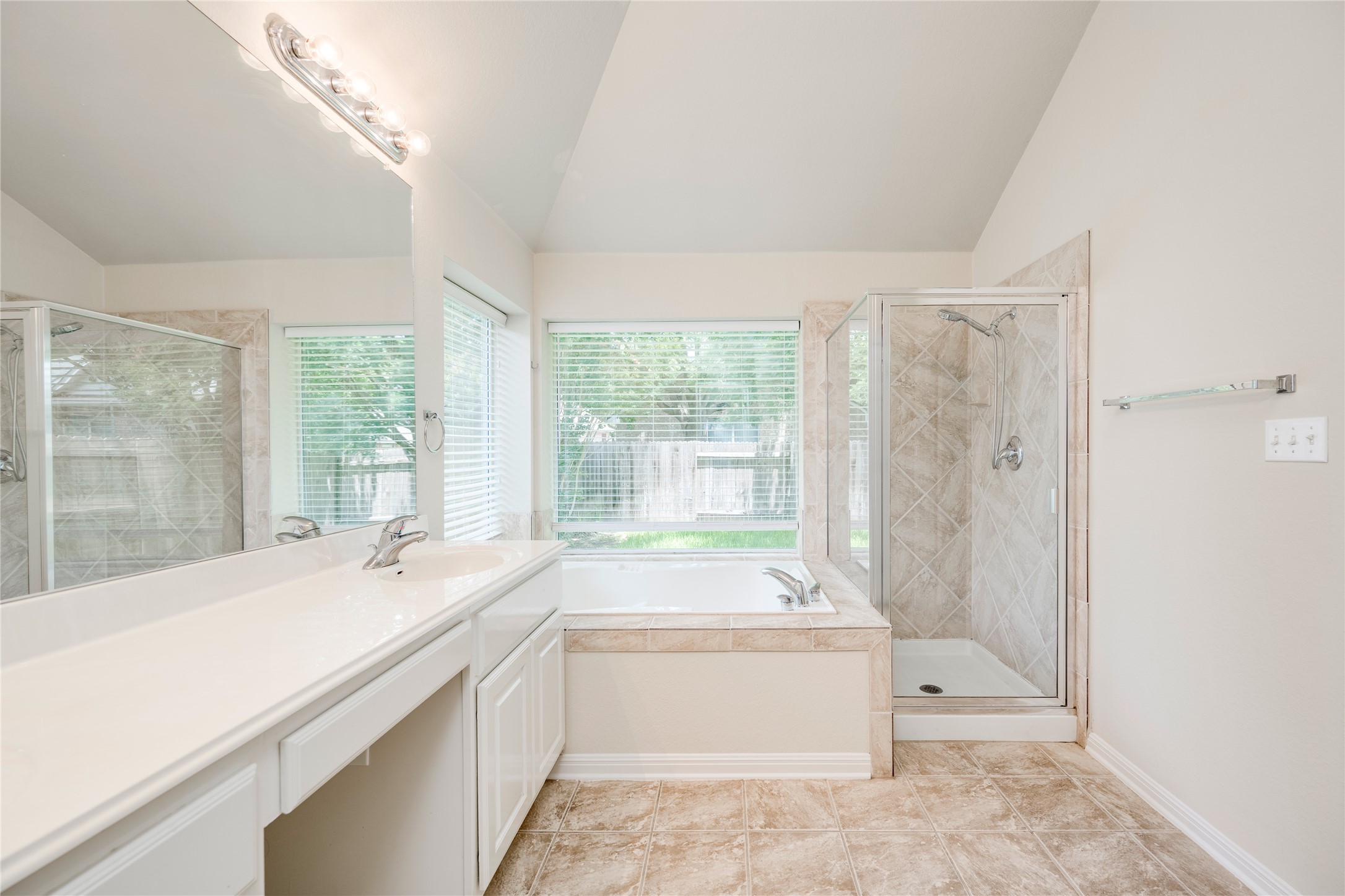 1813 Nelson Ranch Loop Cedar Park, TX 78613 - Photo 21 of 39 A well-lit bathroom features a spacious soaking tub, separate shower, and broad vanity with ample counter space.