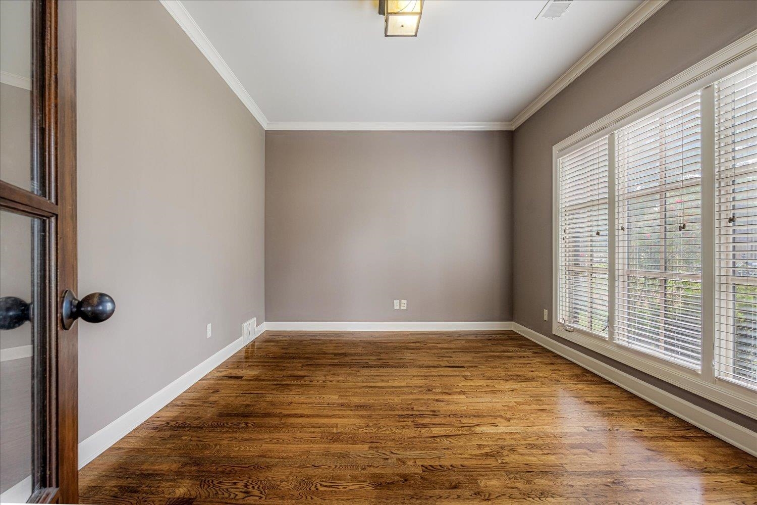 4597 Whisper Spring Drive Collierville, TN 38017 - Photo 11 of 40 Spare room with ornamental molding and wood finished floors
