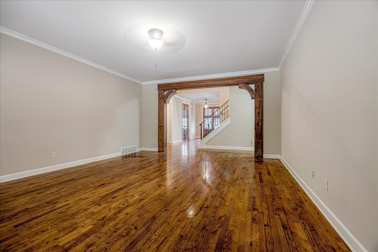 4597 Whisper Spring Drive Collierville, TN 38017 - Photo 13 of 40 Spare room with ornamental molding, stairway, wood finished floors, and arched walkways