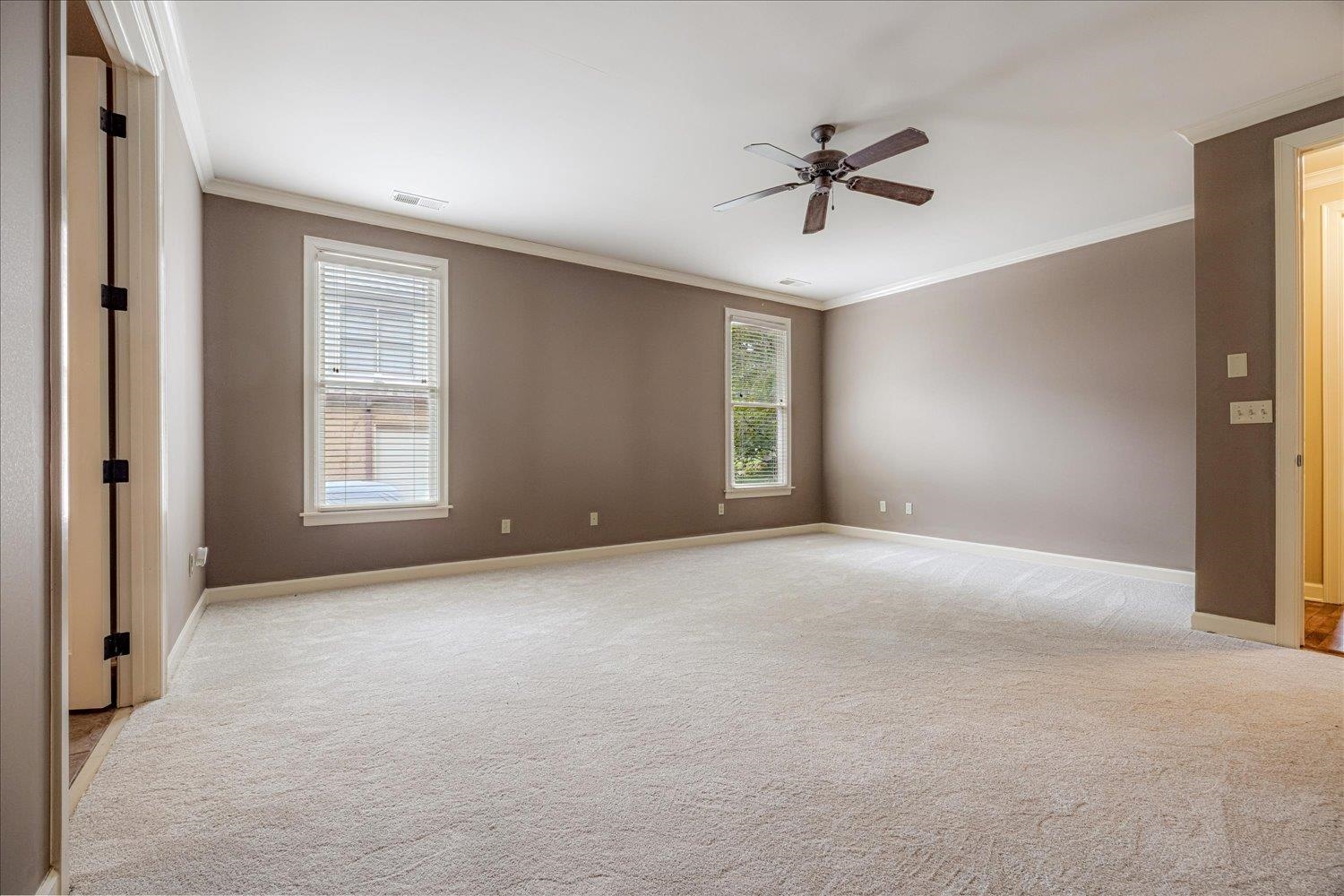 4597 Whisper Spring Drive Collierville, TN 38017 - Photo 19 of 40 Empty room with crown molding, light carpet, and a ceiling fan