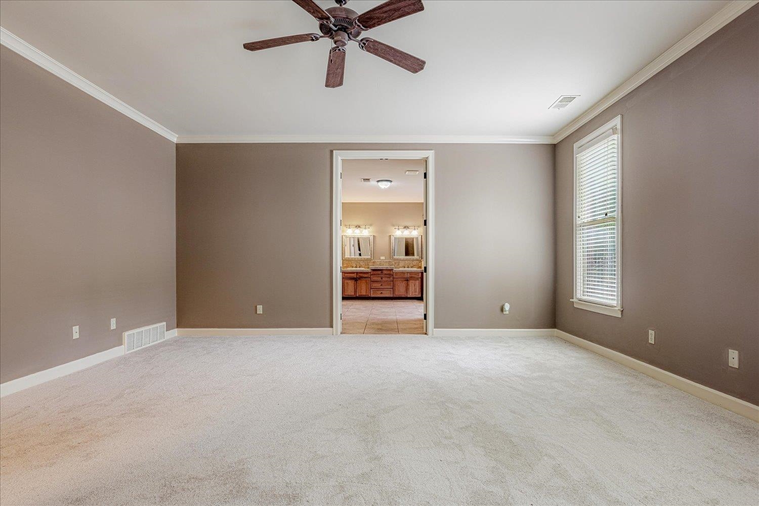 4597 Whisper Spring Drive Collierville, TN 38017 - Photo 20 of 40 Empty room with ornamental molding, ceiling fan, and light colored carpet