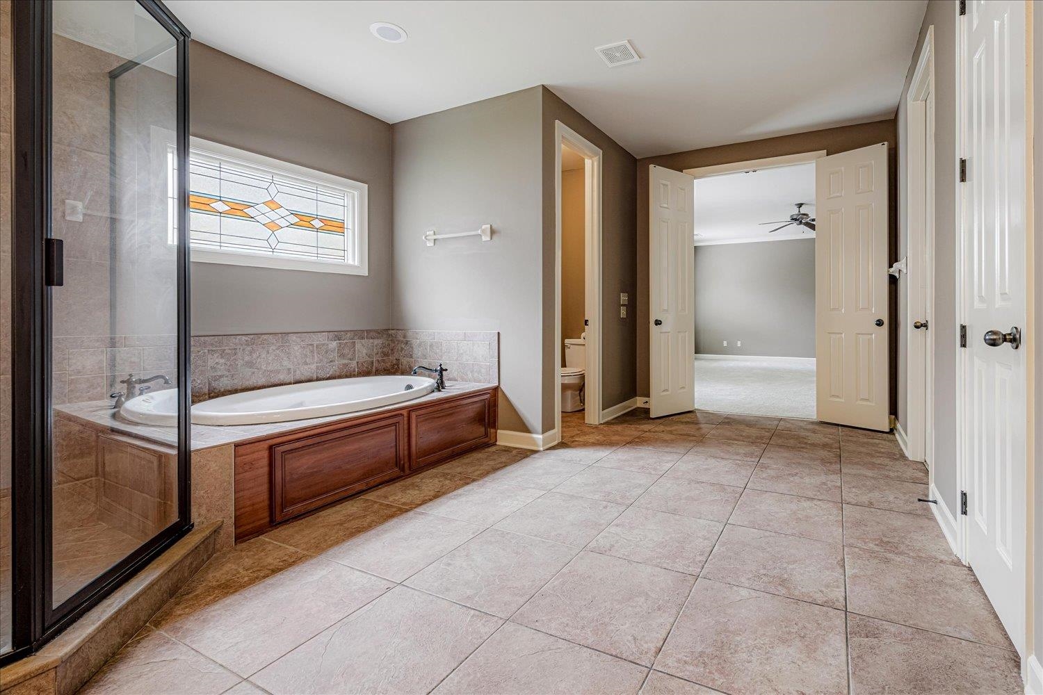 4597 Whisper Spring Drive Collierville, TN 38017 - Photo 23 of 40 Bathroom featuring a garden tub, a stall shower, and light tile patterned floors