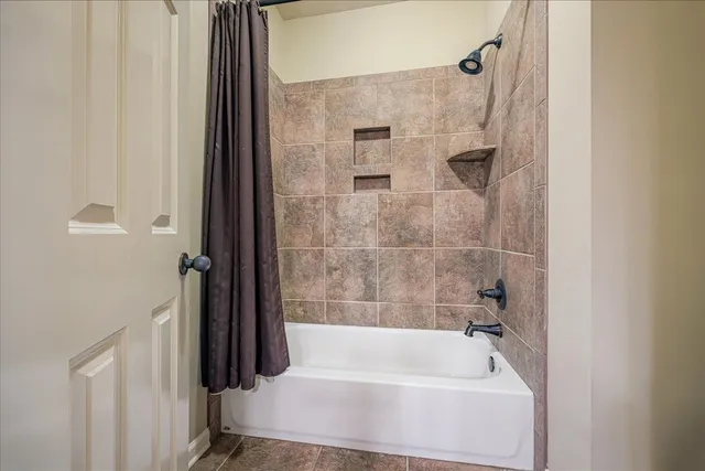 a bathroom with a tub and shower
