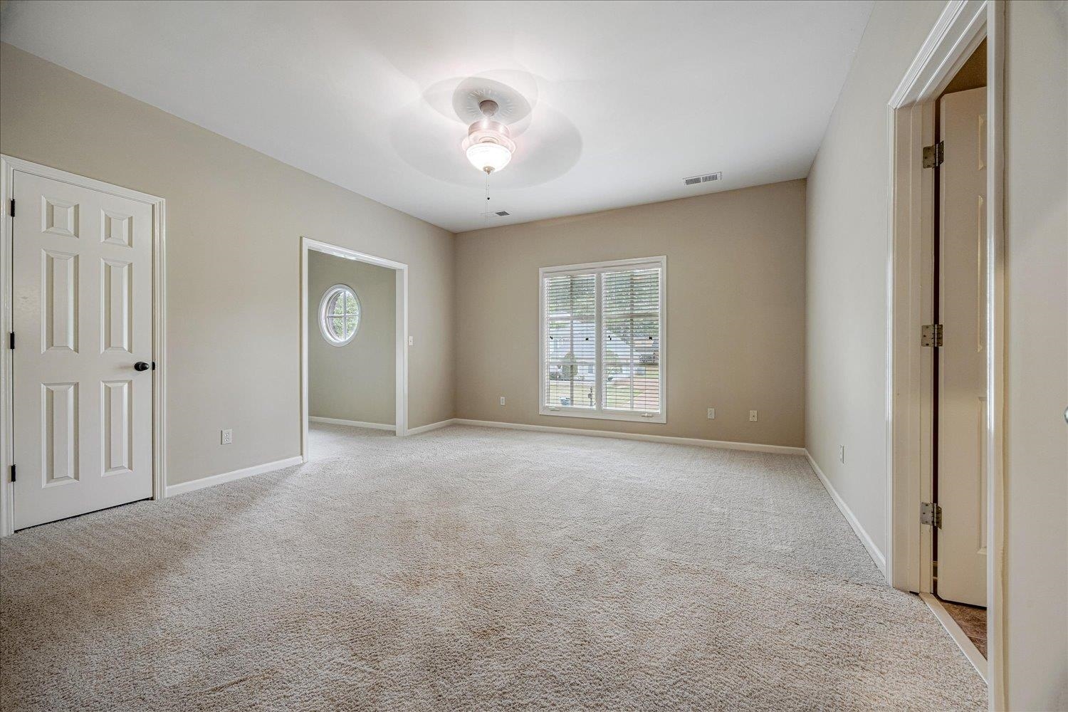4597 Whisper Spring Drive Collierville, TN 38017 - Photo 27 of 40 Unfurnished bedroom featuring light colored carpet and a ceiling fan