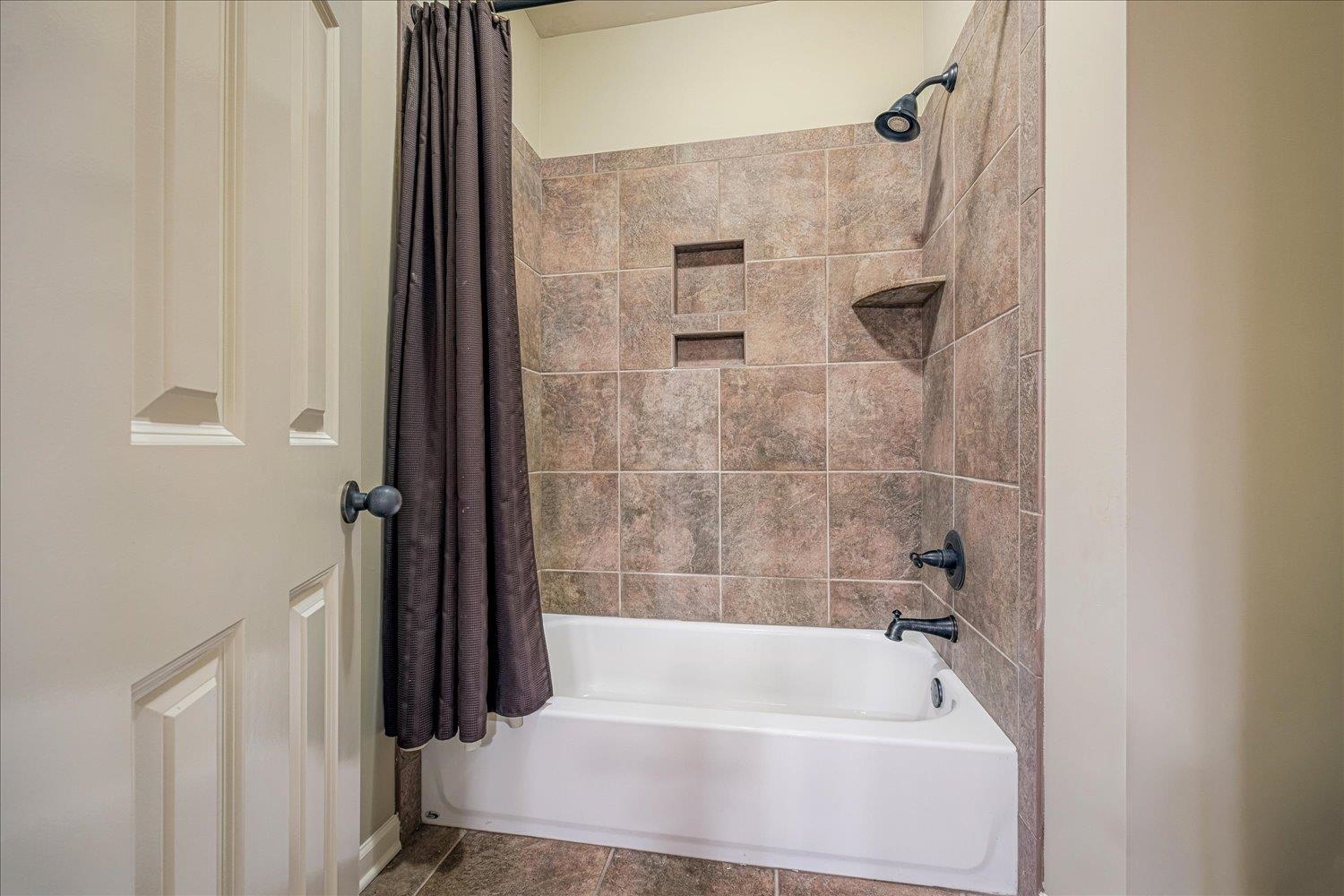 4597 Whisper Spring Drive Collierville, TN 38017 - Photo 32 of 40 Bathroom featuring shower / bath combo with shower curtain and tile patterned flooring
