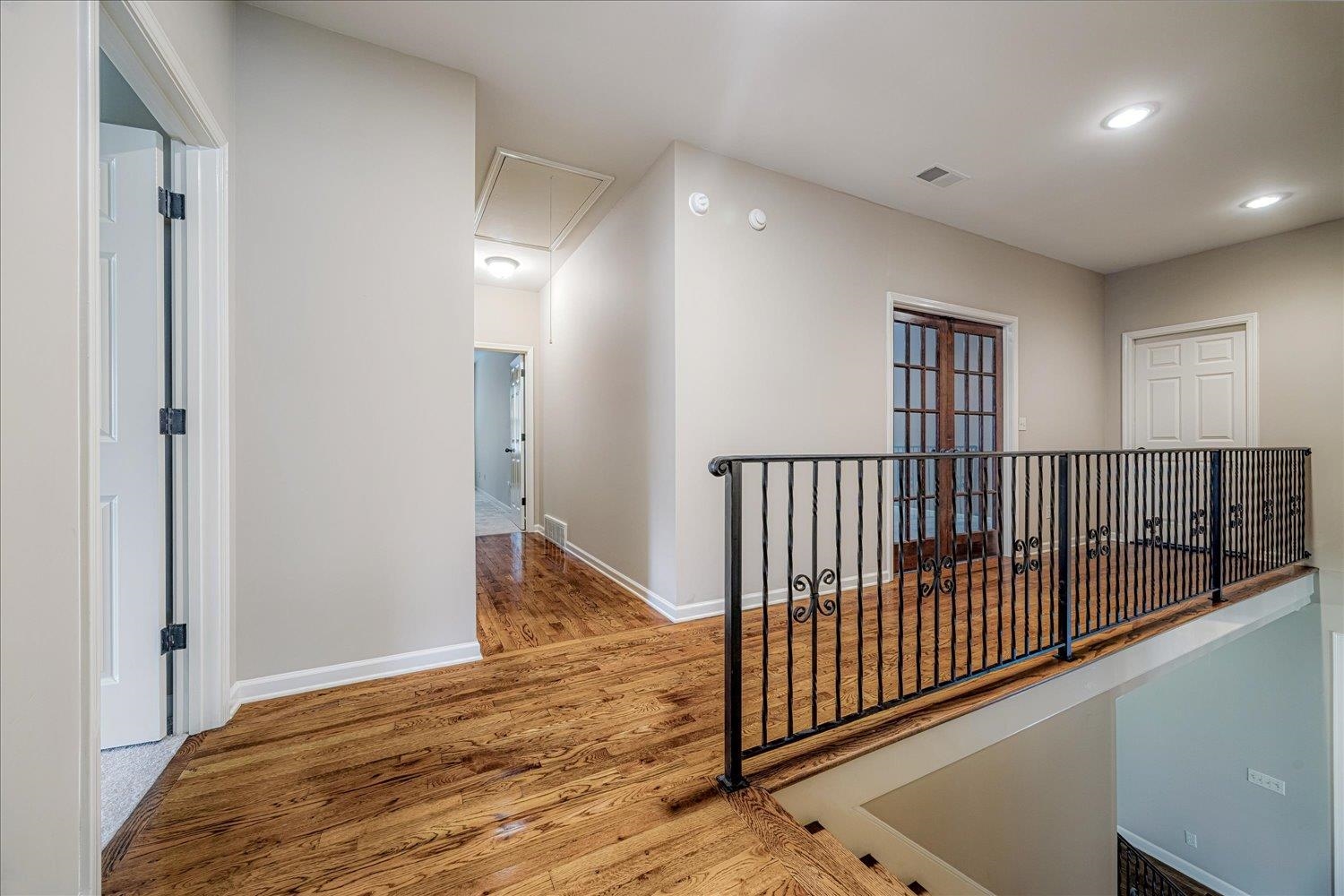 4597 Whisper Spring Drive Collierville, TN 38017 - Photo 34 of 40 Corridor featuring wood finished floors, attic access, and recessed lighting