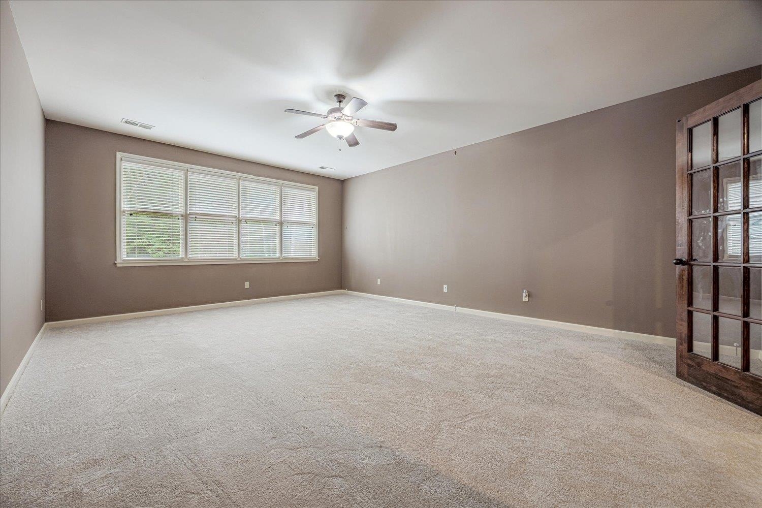 4597 Whisper Spring Drive Collierville, TN 38017 - Photo 36 of 40 Empty room featuring light colored carpet and a ceiling fan