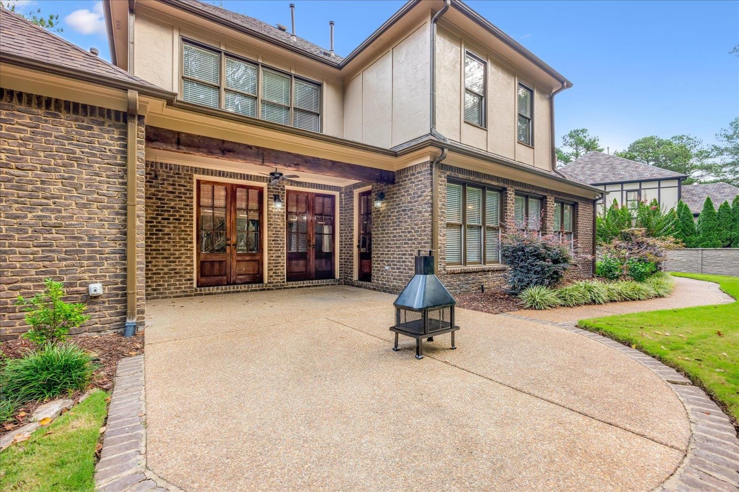 4597 Whisper Spring Drive Collierville, TN 38017 - Photo 38 of 40 Rear view of house with brick siding, a patio area, french doors, and stucco siding