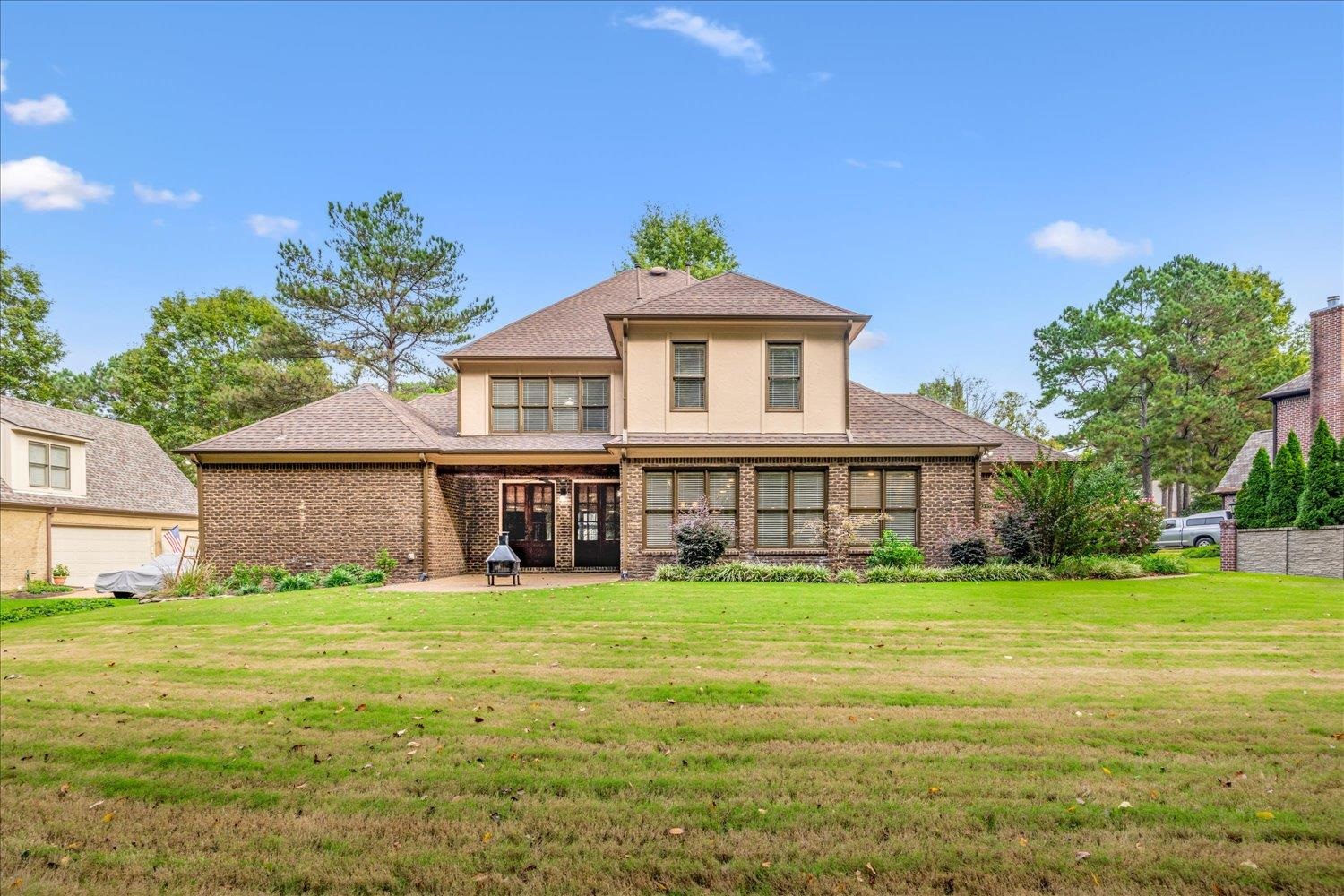 4597 Whisper Spring Drive Collierville, TN 38017 - Photo 5 of 40 Rear view of house featuring a yard, a patio area, brick siding, and roof with shingles