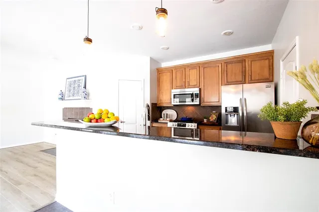 a kitchen with a stove a sink and a refrigerator