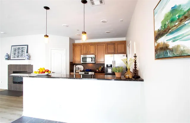 a view of a kitchen with stainless steel appliances