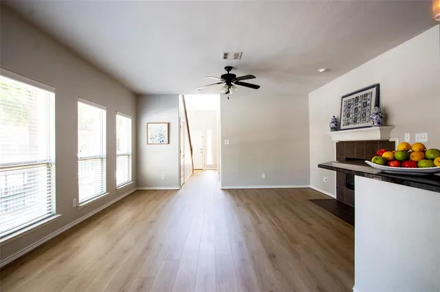 a view of a room with wooden floor and a window