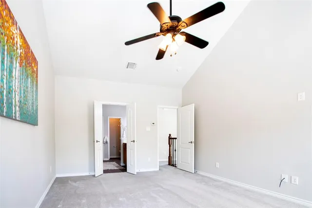 an empty room with closet and windows