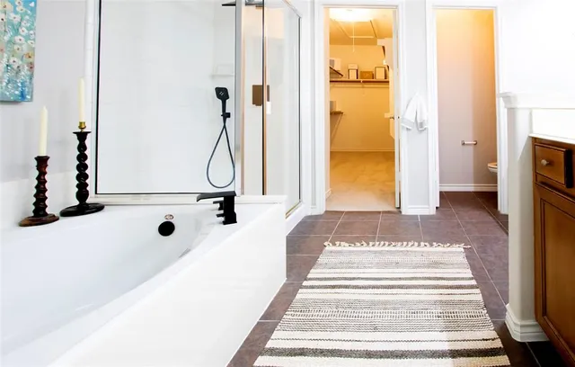 a view of a bathroom with mirror on the wall