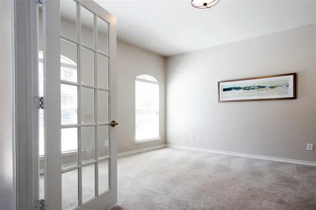 a view of a livingroom with wooden floor and a large window