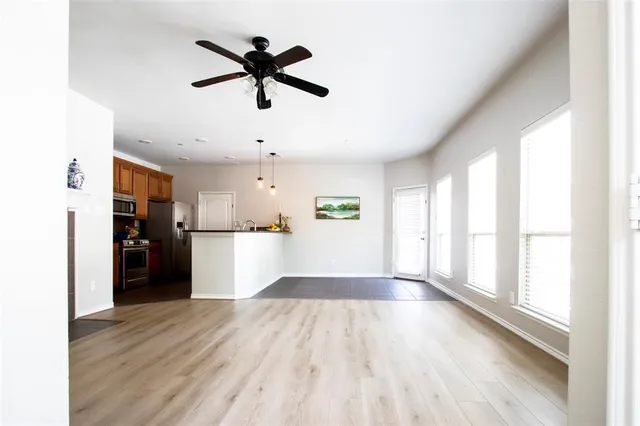 a view of empty room with wooden floor and window