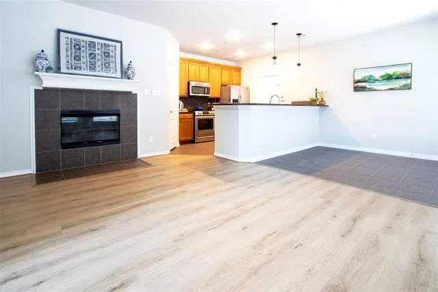 a view of kitchen with wooden floor and a fireplace