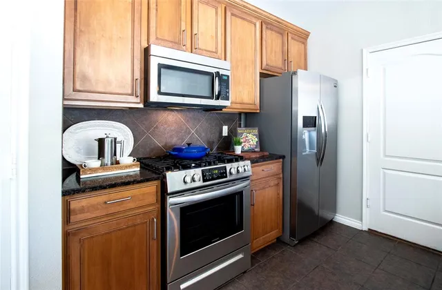 a kitchen with a stove microwave and refrigerator
