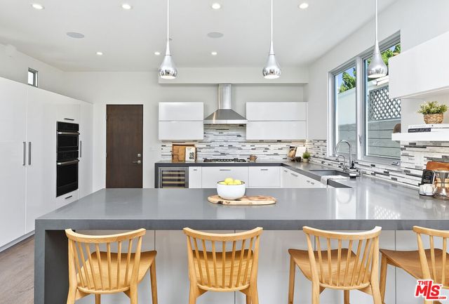 a kitchen with counter top space cabinets and appliances