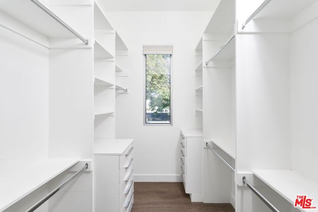 a hallway with stairs and wooden floor