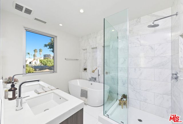 a bathroom with a sink mirror toilet and bathtub