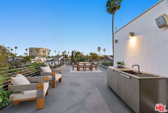 a view of a swimming pool with couches chairs