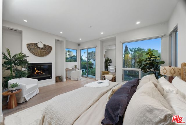 a large bedroom with bed and a fireplace
