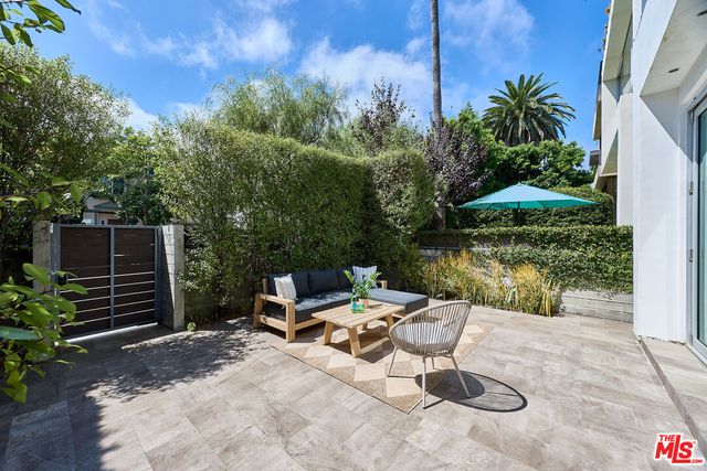 a view of a backyard with chairs and a table