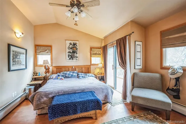 a bedroom with a bed couch and a window