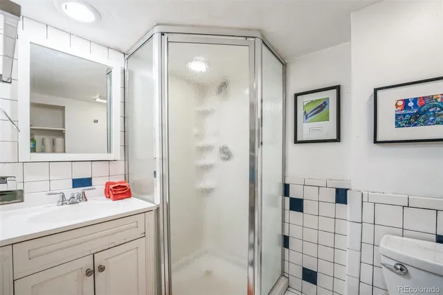 a bathroom with a sink mirror and shower