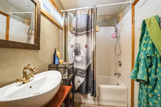 a bathroom with a sink a mirror and a shower