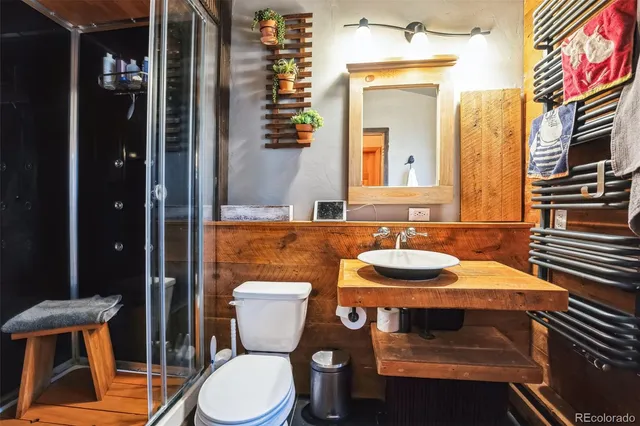 a bathroom with a sink a toilet and mirror
