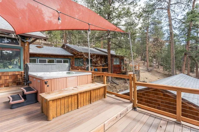 a balcony with wooden floor and barbeque oven