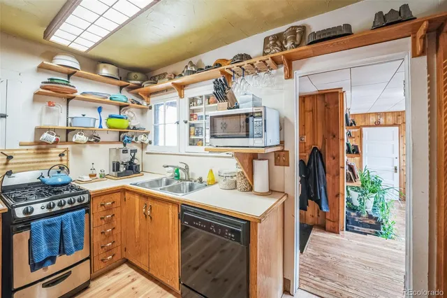 a kitchen with stainless steel appliances a stove a sink and a refrigerator