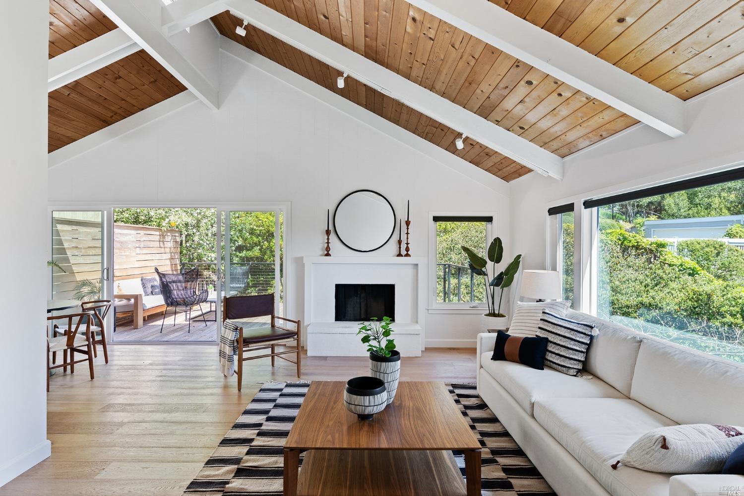 1021 Erica Road Mill Valley, CA 94941 - Photo 1 of 1 a living room with furniture a fireplace a rug and a large window