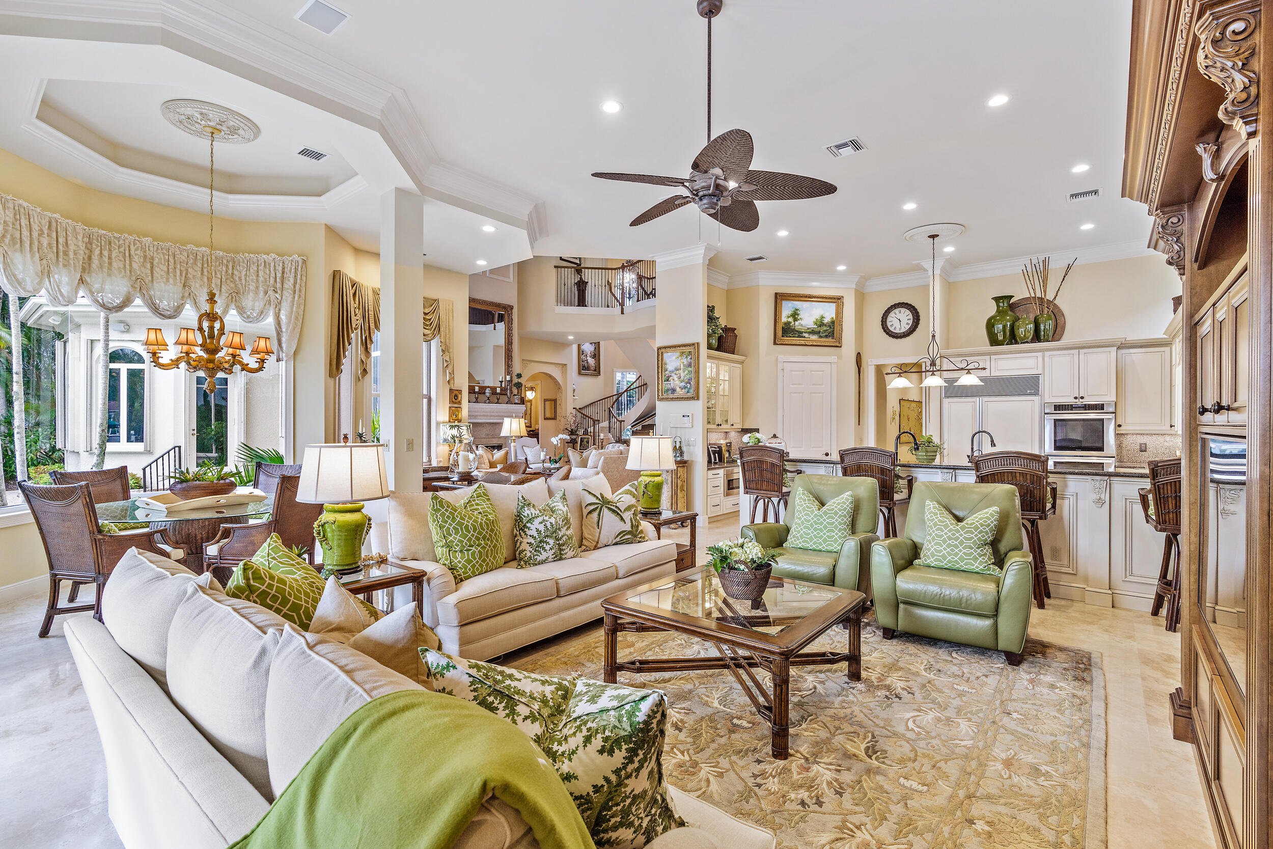 3152 Casseekey Island Road Jupiter, FL 33477 - Photo 16 of 45 a living room with lots of furniture and a chandelier
