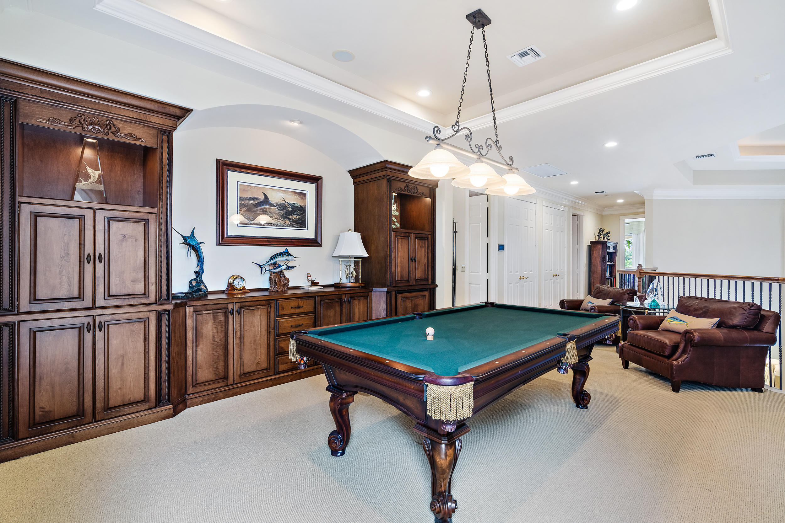 3152 Casseekey Island Road Jupiter, FL 33477 - Photo 26 of 45 a living room with furniture pool table and wall paintings