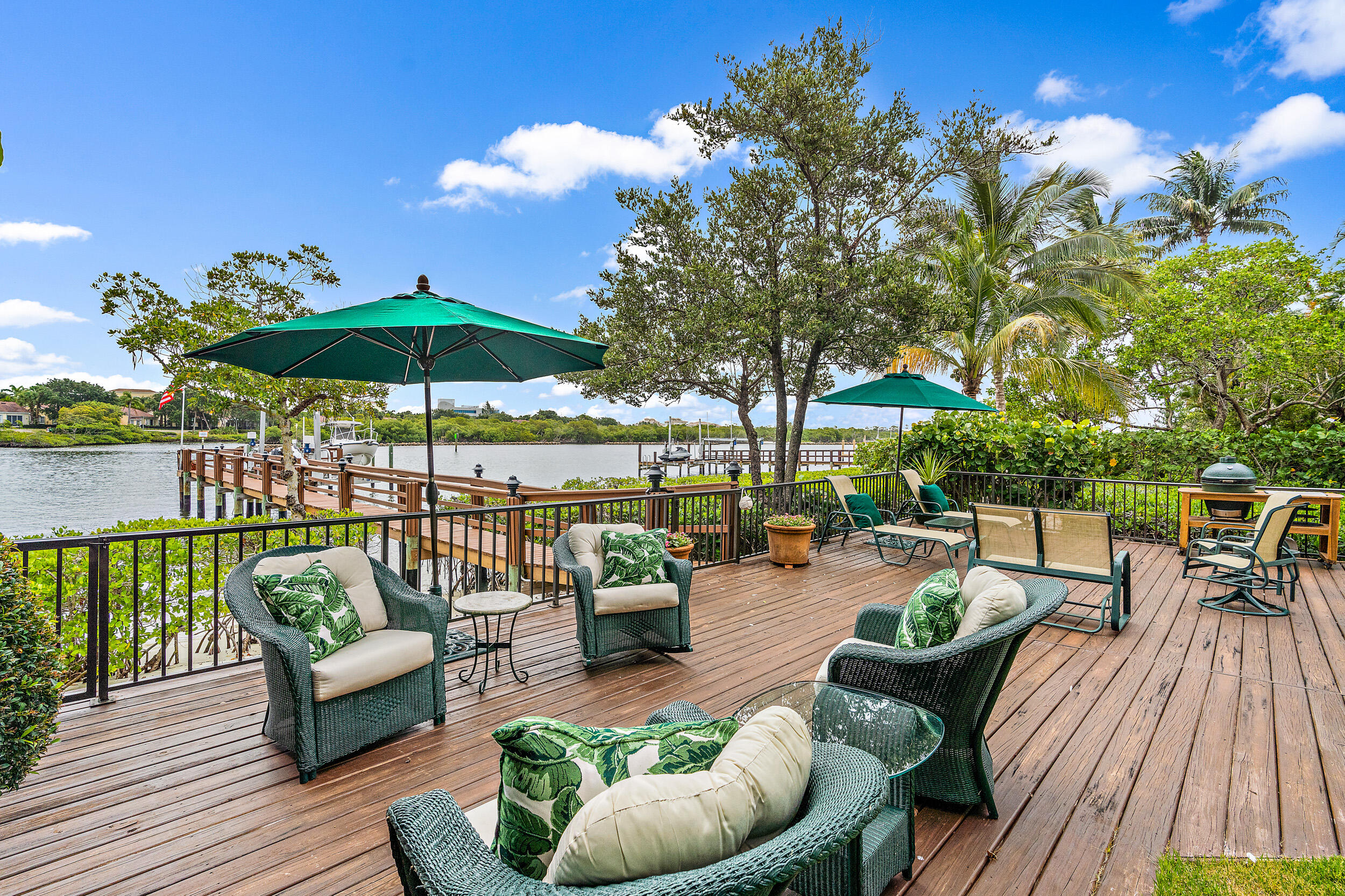3152 Casseekey Island Road Jupiter, FL 33477 - Photo 4 of 45 a view of a patio with couches potted plants and a patio