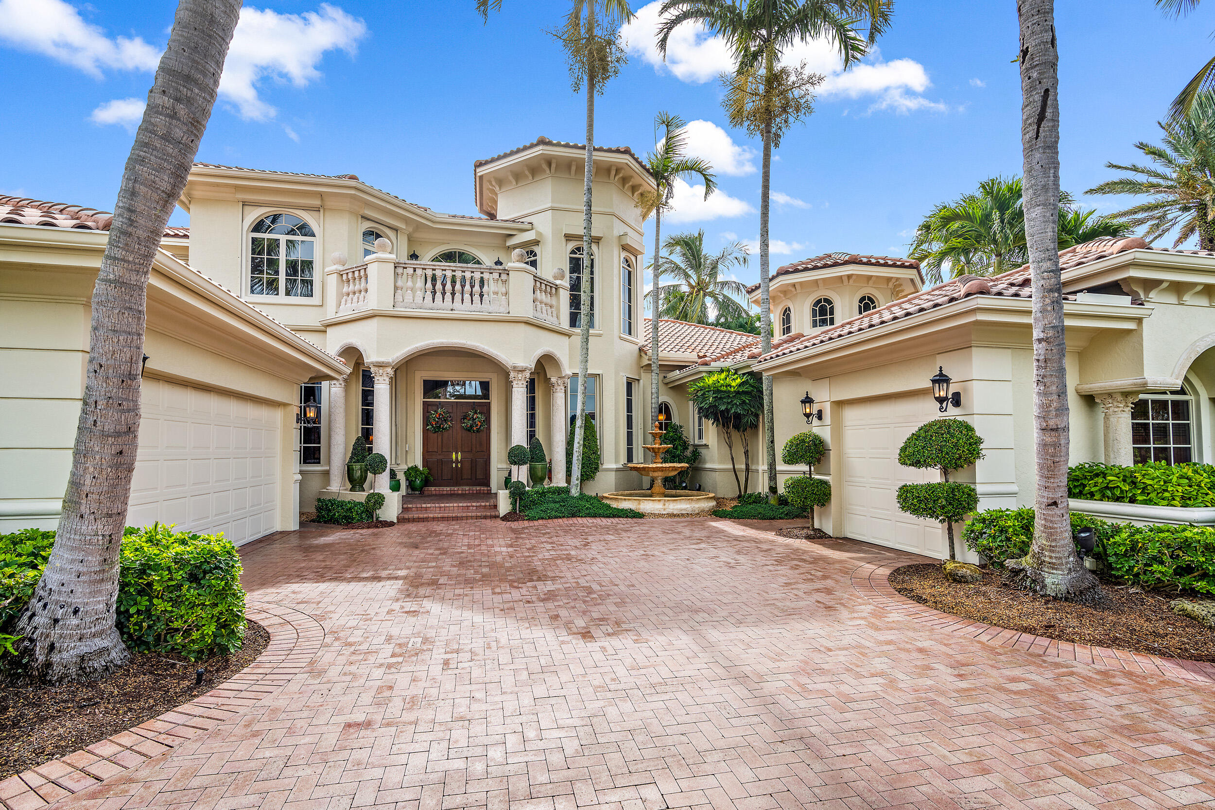 3152 Casseekey Island Road Jupiter, FL 33477 - Photo 9 of 45 a view of a white house with a yard and plants
