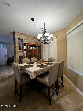 a view of a dining room with furniture and chandelier