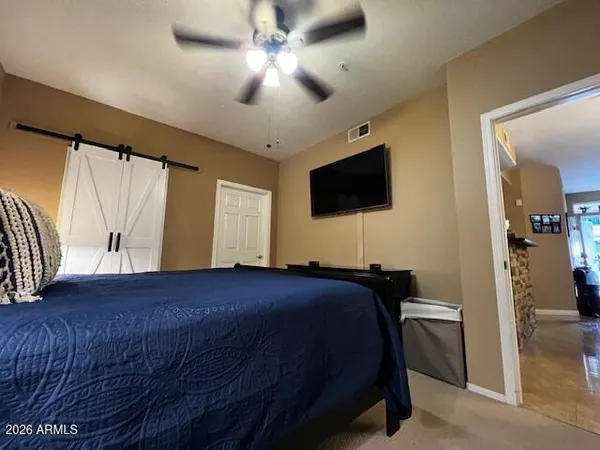 a bedroom with a bed and a flat screen tv