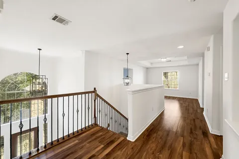 a view of hallway with wooden floor