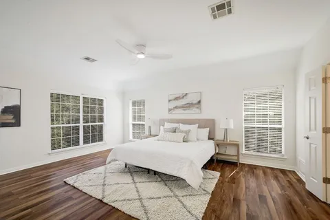 a bedroom with a large bed and a window