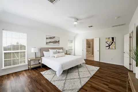 a living room with a bed furniture and a window